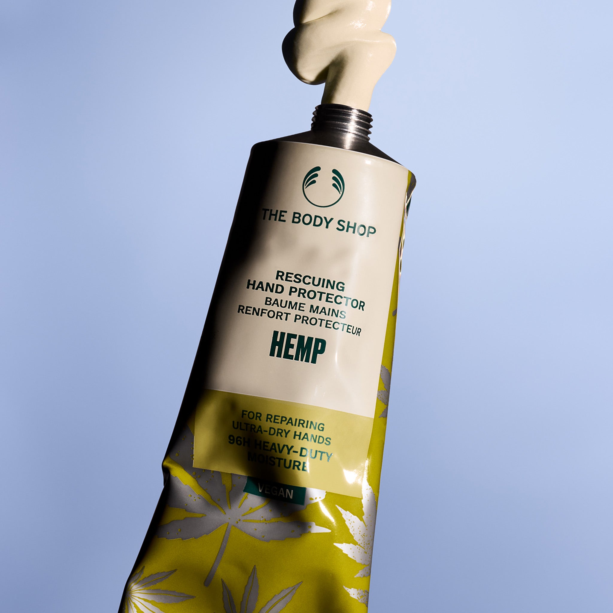 The Body Shop hemp hand protector tube on a blue background