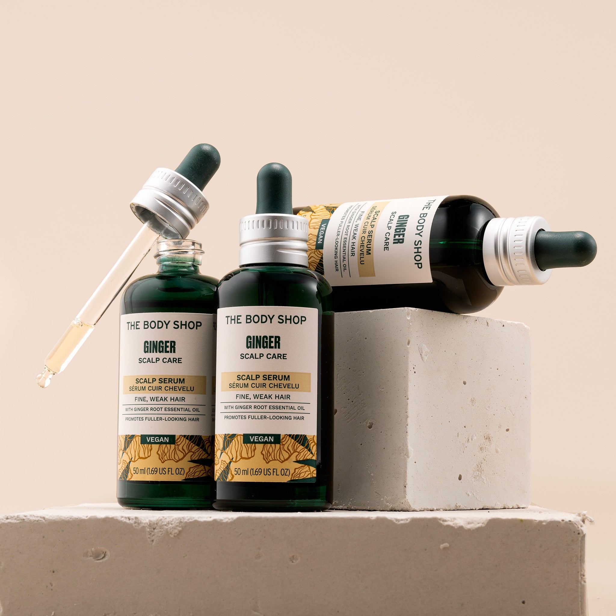 The Body Shop Ginger Scalp Care Serum products on a neutral background