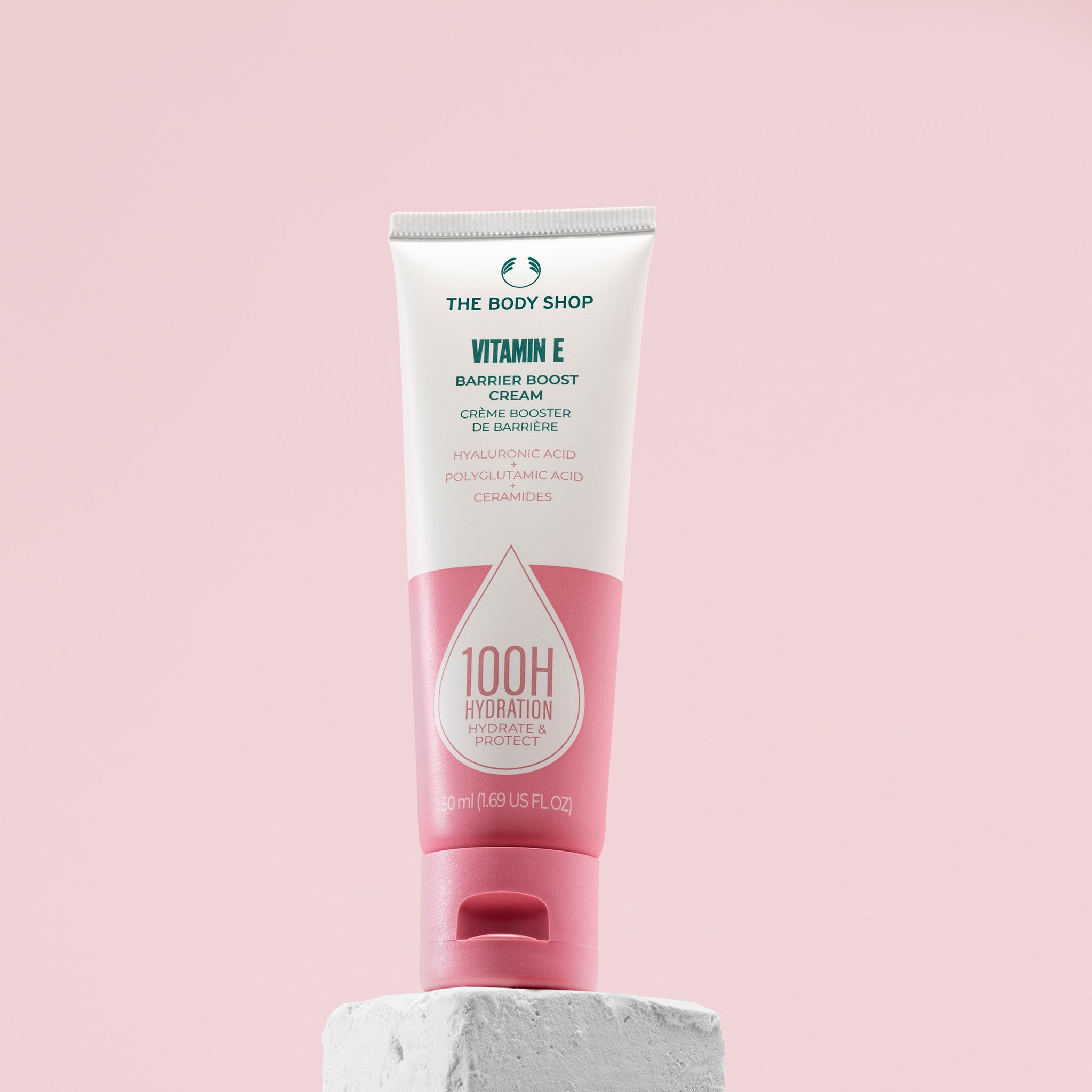 Vitamin E Barrier Boost Cream - The Body Shop on a pink lifestyle background